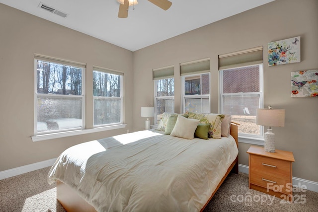 bedroom featuring ceiling fan, carpet floors, and multiple windows