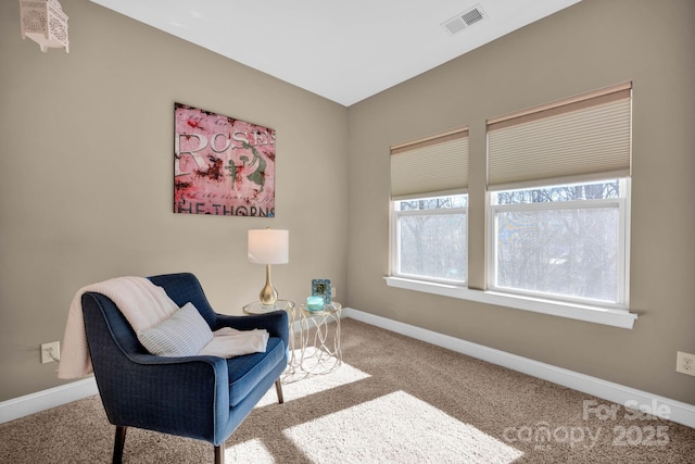 living area featuring light carpet