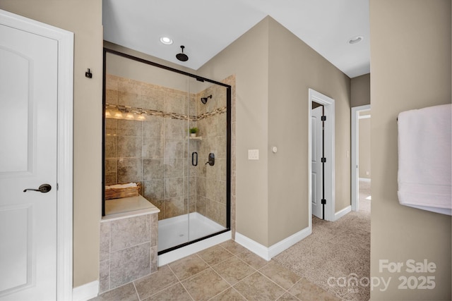 bathroom with an enclosed shower and tile patterned floors