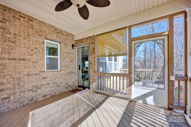 sunroom featuring ceiling fan