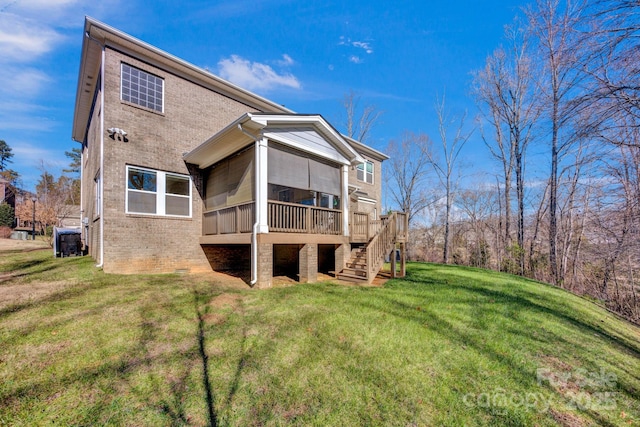 back of house with a sunroom and a lawn