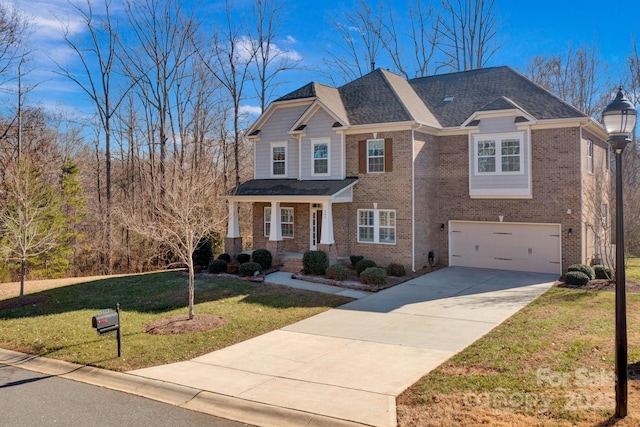 craftsman-style home featuring a garage and a front yard