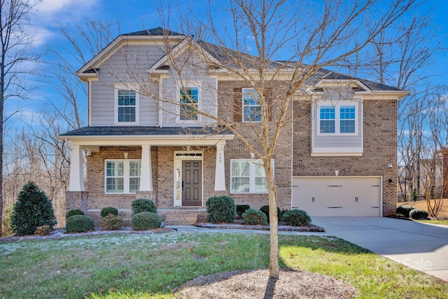 craftsman-style home featuring a front yard and a garage