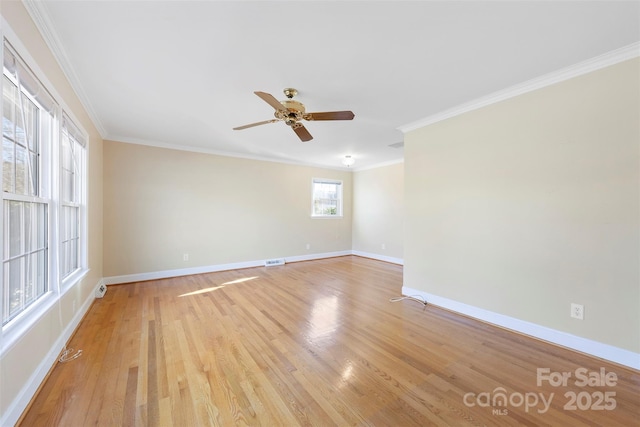 empty room featuring ceiling fan, crown molding, and light hardwood / wood-style flooring