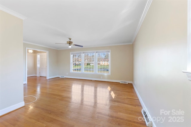 spare room with light wood-type flooring, ceiling fan, and crown molding