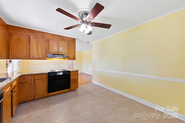 kitchen featuring ceiling fan, oven, light stone countertops, a textured ceiling, and ornamental molding