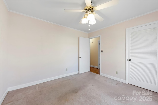 unfurnished bedroom with light carpet, ceiling fan, ornamental molding, and a closet