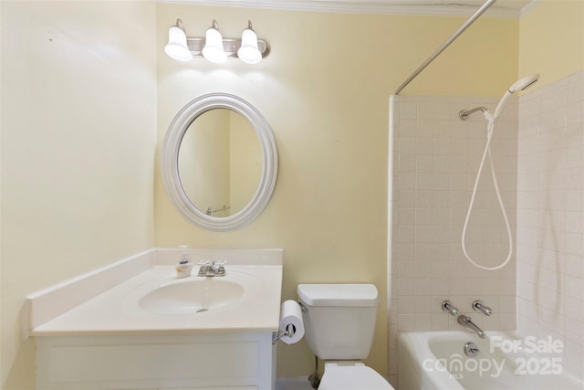 full bathroom with toilet, ornamental molding, tiled shower / bath, and vanity