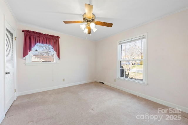 unfurnished room with ceiling fan, ornamental molding, and light colored carpet