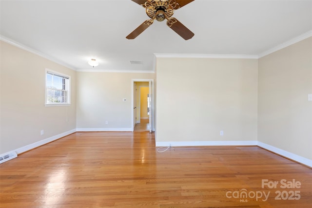 spare room featuring ceiling fan, ornamental molding, and light wood-type flooring