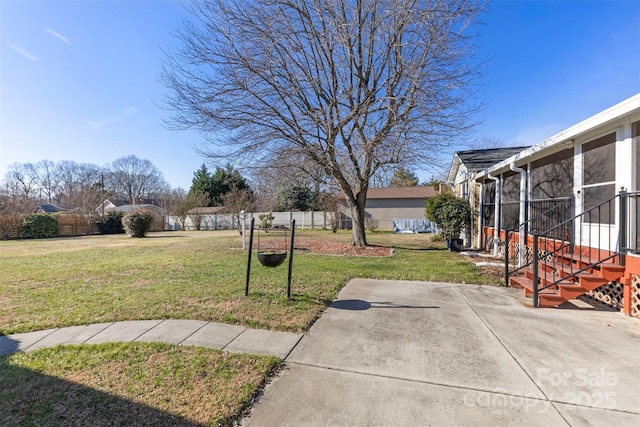 view of yard featuring a sunroom and a patio