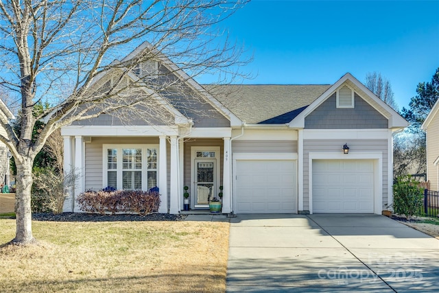 view of front of home with a garage and a front yard