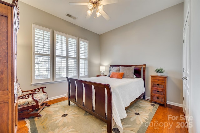 bedroom with ceiling fan and light hardwood / wood-style flooring