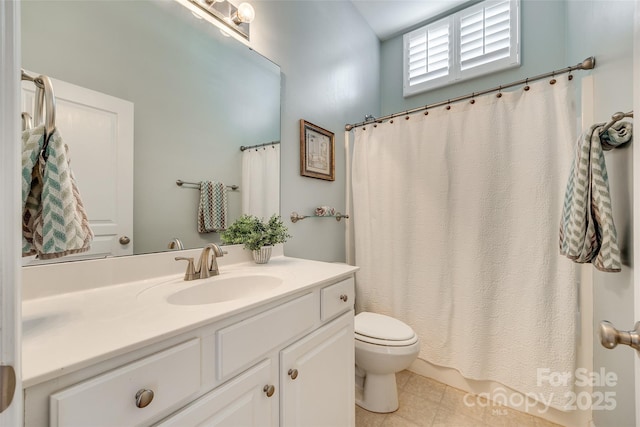 bathroom featuring toilet and vanity