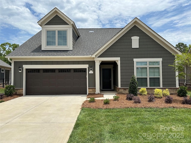 view of front facade with a garage and a front yard