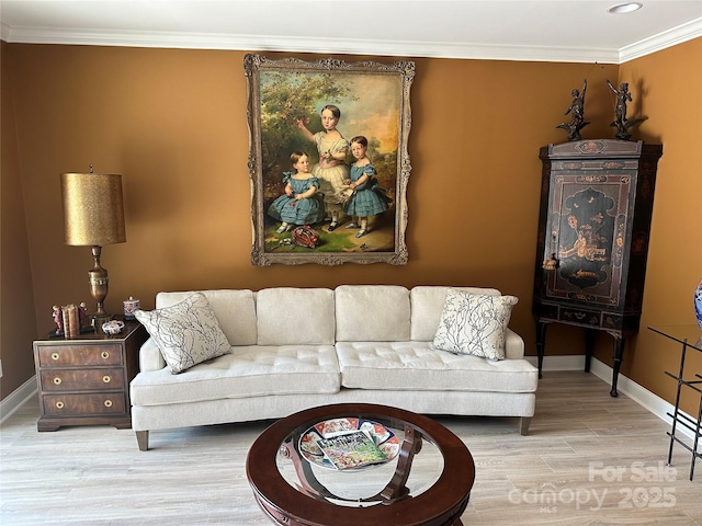 living room featuring light wood-type flooring and ornamental molding