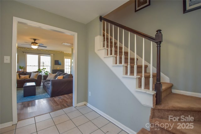 stairs featuring ceiling fan and tile patterned flooring