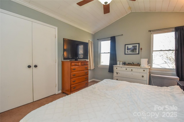 bedroom with light carpet, ceiling fan, wooden ceiling, a closet, and vaulted ceiling