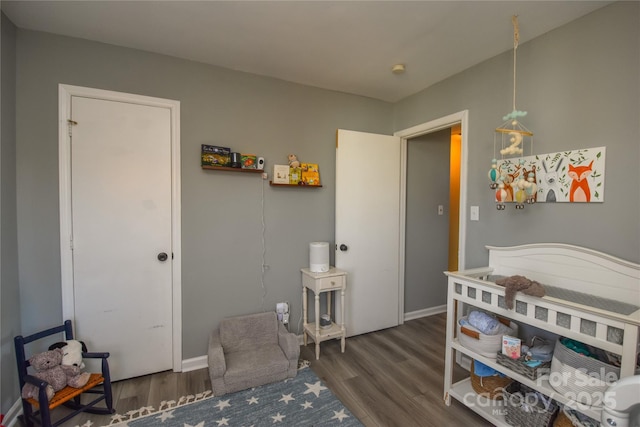 bedroom with dark hardwood / wood-style flooring