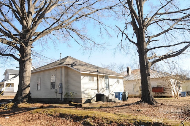 view of side of home with central AC unit