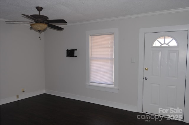 entrance foyer with a textured ceiling, ceiling fan, ornamental molding, and dark hardwood / wood-style floors