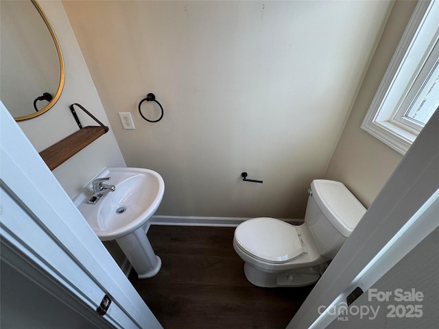 bathroom with toilet and hardwood / wood-style floors