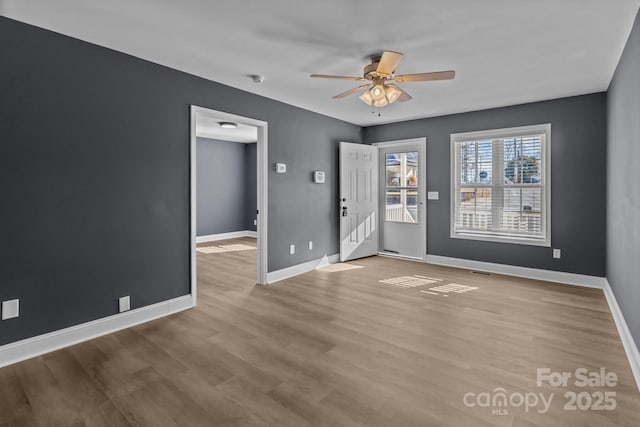 empty room featuring ceiling fan and light hardwood / wood-style flooring