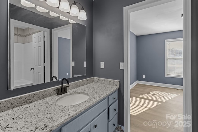 bathroom featuring hardwood / wood-style flooring and vanity