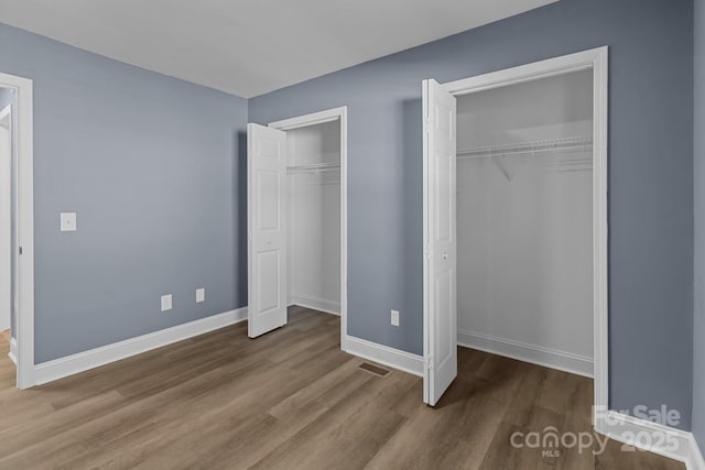 unfurnished bedroom featuring hardwood / wood-style flooring