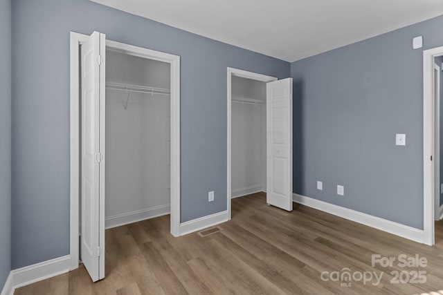 unfurnished bedroom with light wood-type flooring