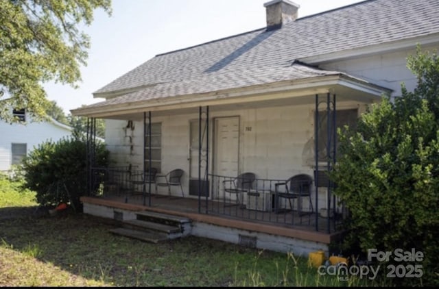 rear view of house with a porch