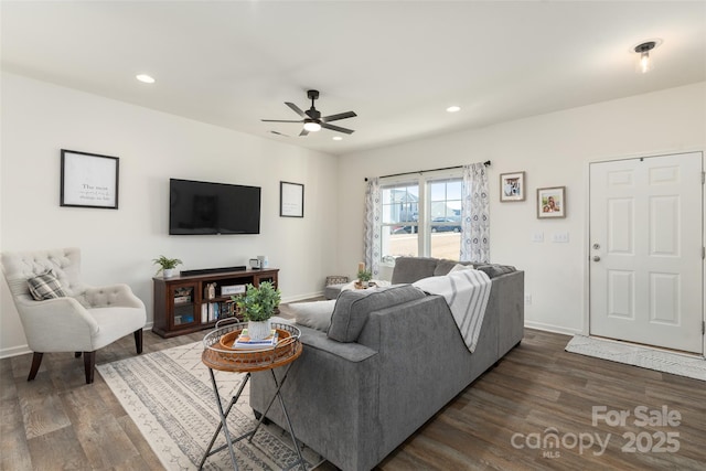 living room with dark wood-type flooring and ceiling fan