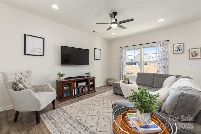 living room with hardwood / wood-style flooring and ceiling fan