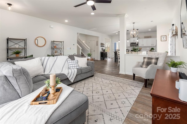 living room featuring ceiling fan and light hardwood / wood-style floors