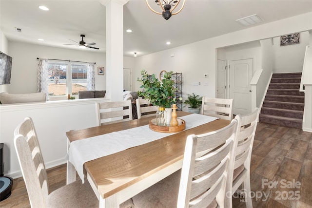 dining space with dark wood-type flooring, ceiling fan, and ornate columns