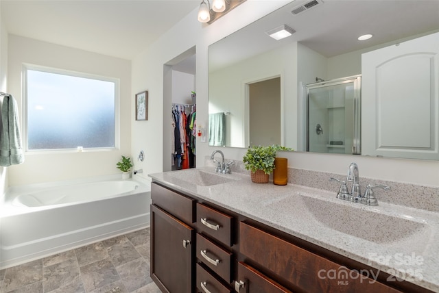 bathroom featuring vanity and shower with separate bathtub