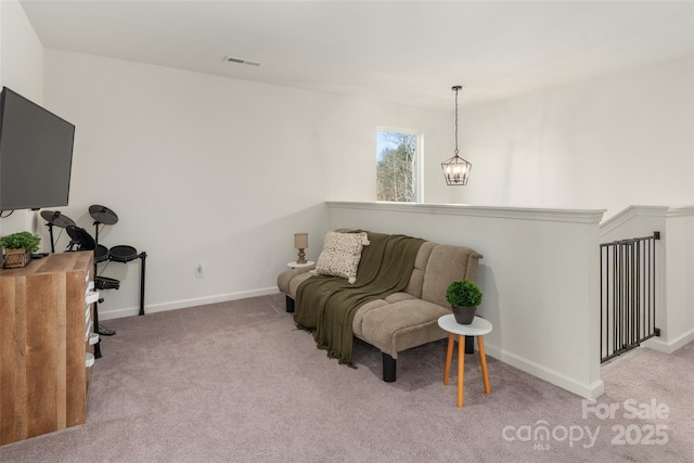 living area featuring light colored carpet and a notable chandelier