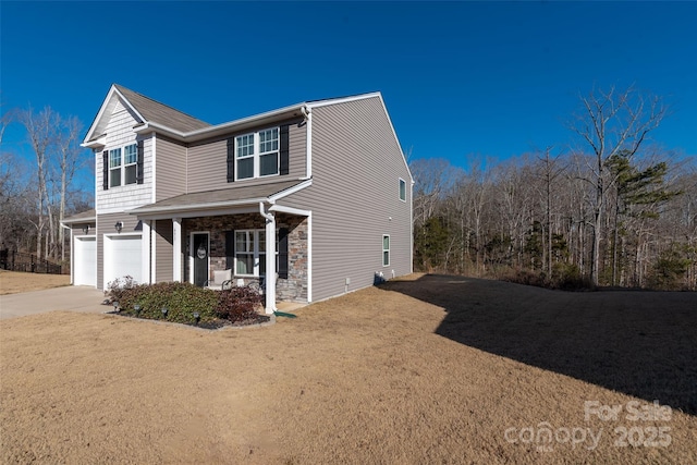 view of front of home featuring a garage, a front lawn, and a porch