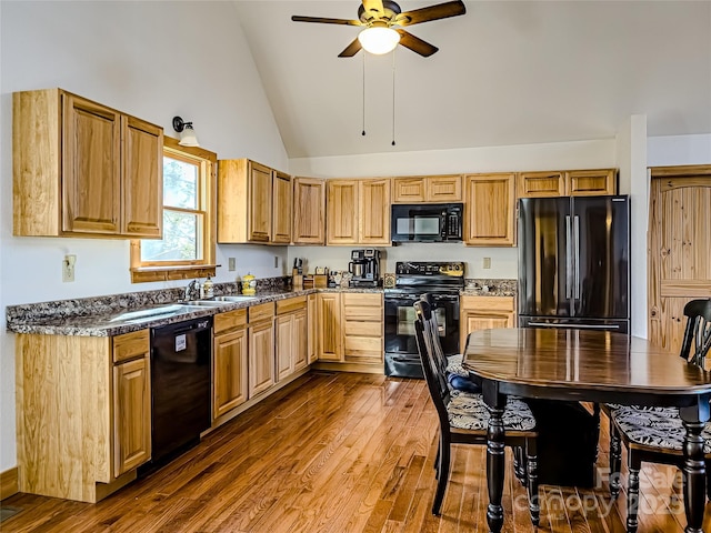 kitchen featuring dark hardwood / wood-style floors, high vaulted ceiling, sink, ceiling fan, and black appliances