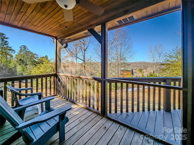 wooden terrace featuring ceiling fan