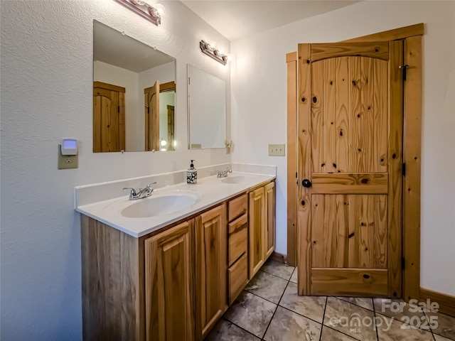 bathroom with vanity and tile patterned flooring