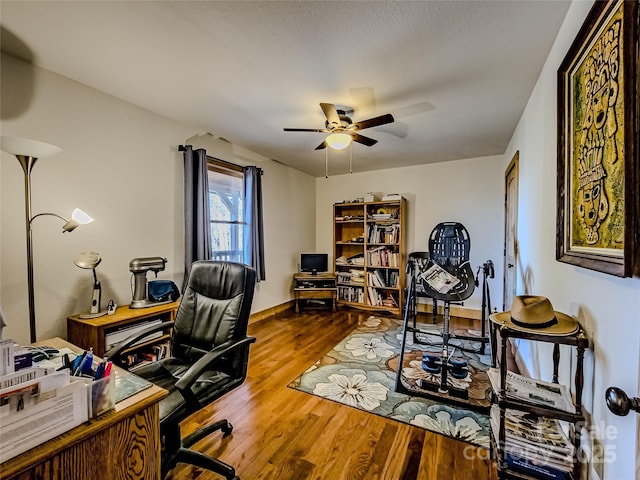 office space with ceiling fan and hardwood / wood-style floors