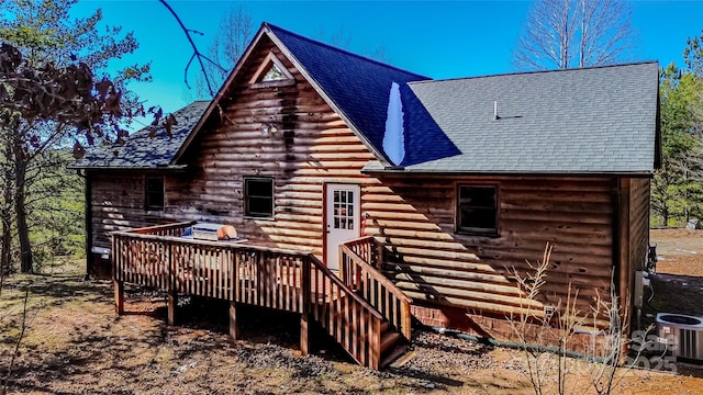 rear view of house with a wooden deck and central AC