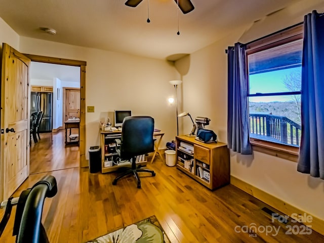 office area with hardwood / wood-style flooring and ceiling fan