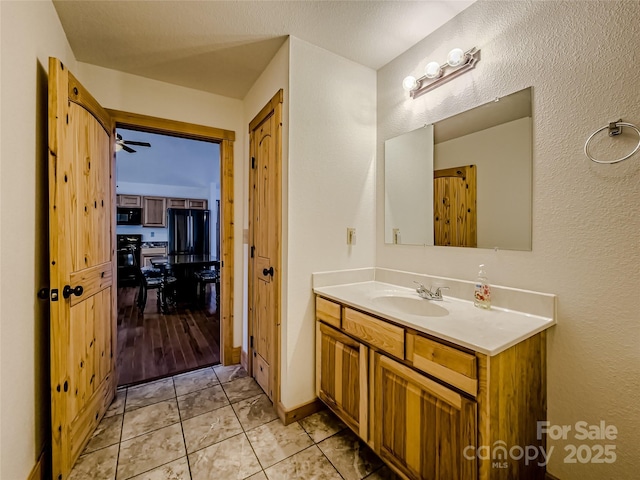 bathroom with vanity, tile patterned floors, and ceiling fan