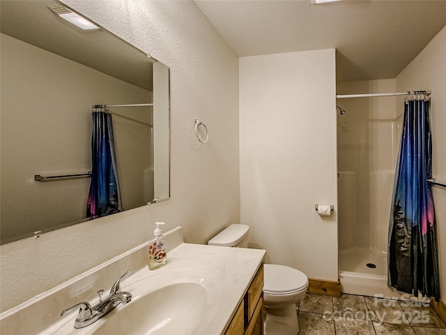 bathroom featuring tile patterned flooring, a shower with shower curtain, vanity, a textured ceiling, and toilet