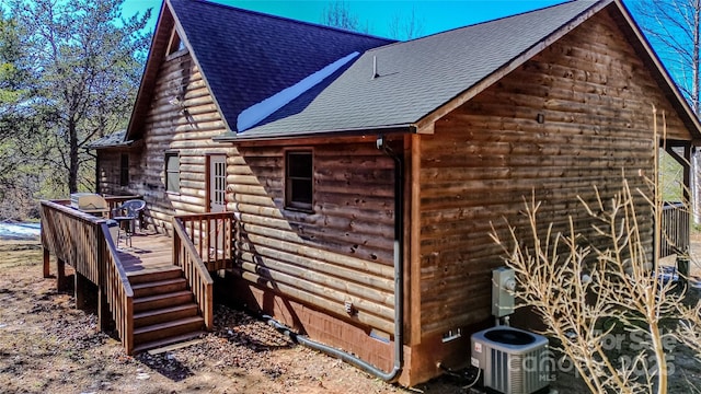 view of side of home featuring a wooden deck and central AC