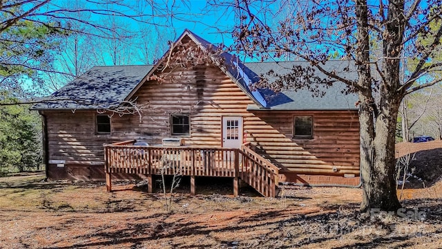 back of property with a wooden deck