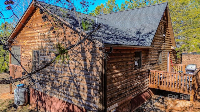 view of home's exterior featuring a wooden deck