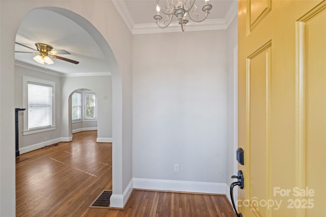 entryway featuring ornamental molding, dark hardwood / wood-style flooring, and ceiling fan with notable chandelier